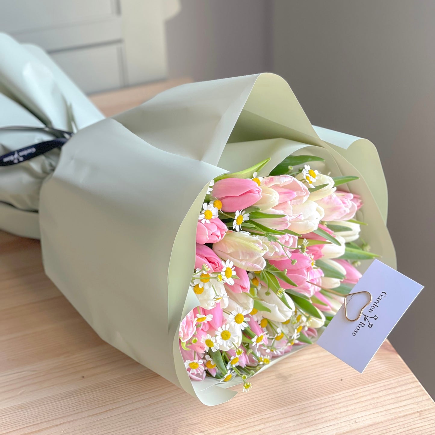 This bouquet has a total of 50 tulips wrapped in paper and is a lovely bouquet to offer happiness to someone you love or care about. It also contains chamomile, which helps to enhance the day even more. 