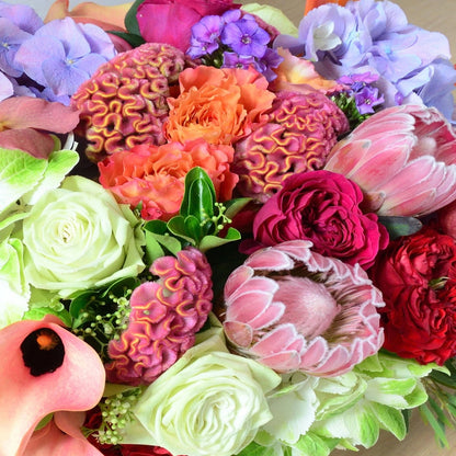 Summer is here, with cold beverages, long walks in the park, and picnics. Allow our designers to select the finest early summer blossoms. Colors and flowers will vary depending on what's available at the market.  NOTE: Blooms are delivered in a vase.