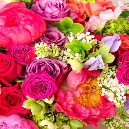 Allow our florists to select the finest and freshest spring flowers for your arrangement, which includes peonies. Colors and flowers will vary depending on what's available at the market.  NOTE: Blooms are delivered in a vase.