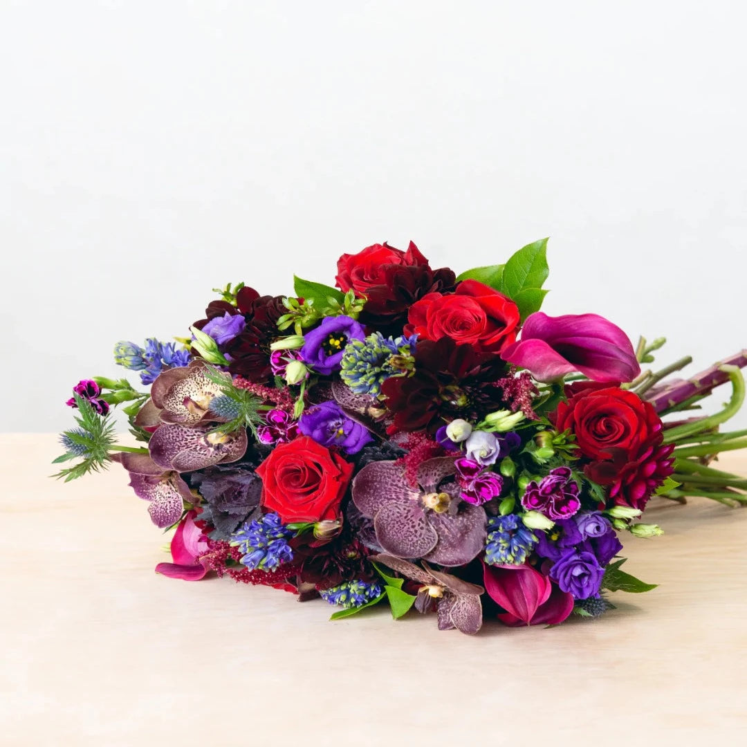 Colors that are vivid, bright, and rich. Depending on the season, the flowers featured will vary. Allow our designer to create a unique arrangement for your home or any occasion   NOTE: Blooms are delivered in a vase.