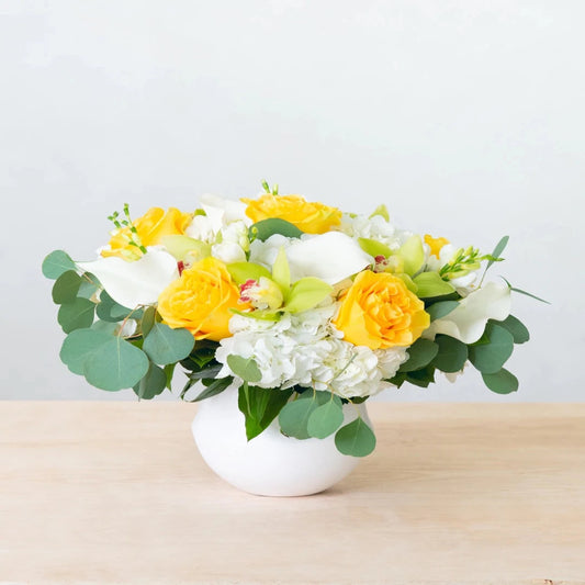 The Griffith Park bouquet is a delicate blend of whites, greens, and flashes of yellow, named after one of California's most popular parks. A stunning arrangement of white hydrangea, green orchids, yellow roses, and eucalyptus greenery to brighten your day.